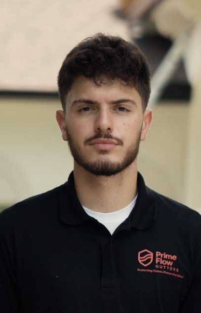 Nicholas Dos Santos, Founder of PrimeFlow Gutters, wearing a black PrimeFlow polo