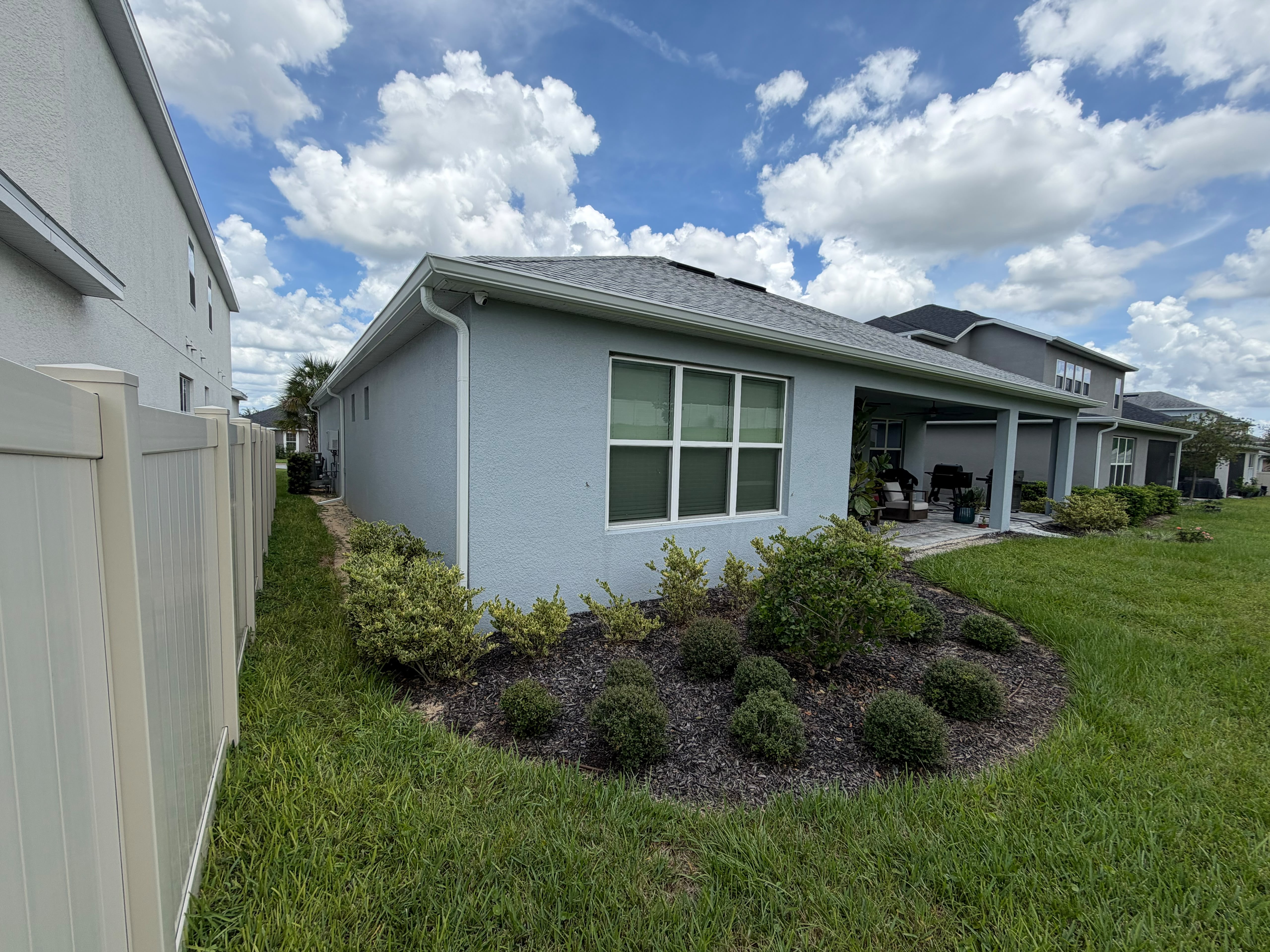 Newer Florida home with finished landscaping and a visible roofline